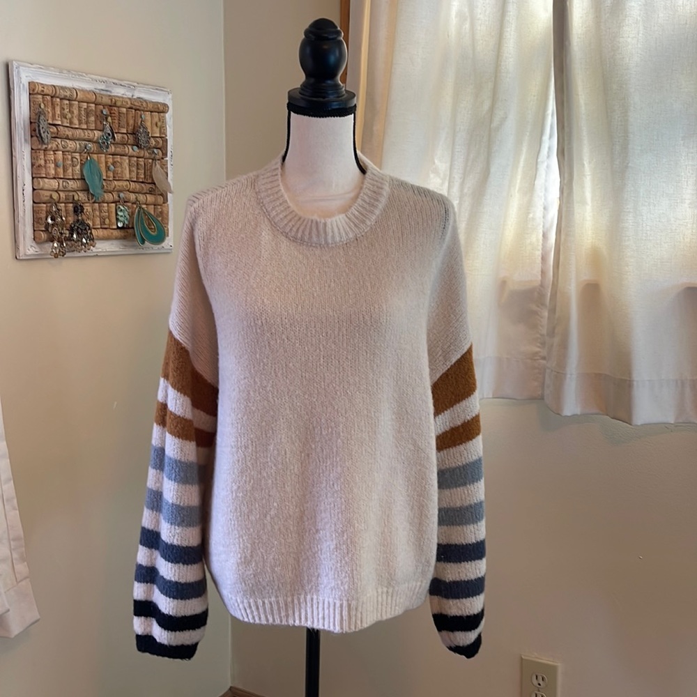 Pink Lily cream sweater with striped balloon sleeves. Size Medium